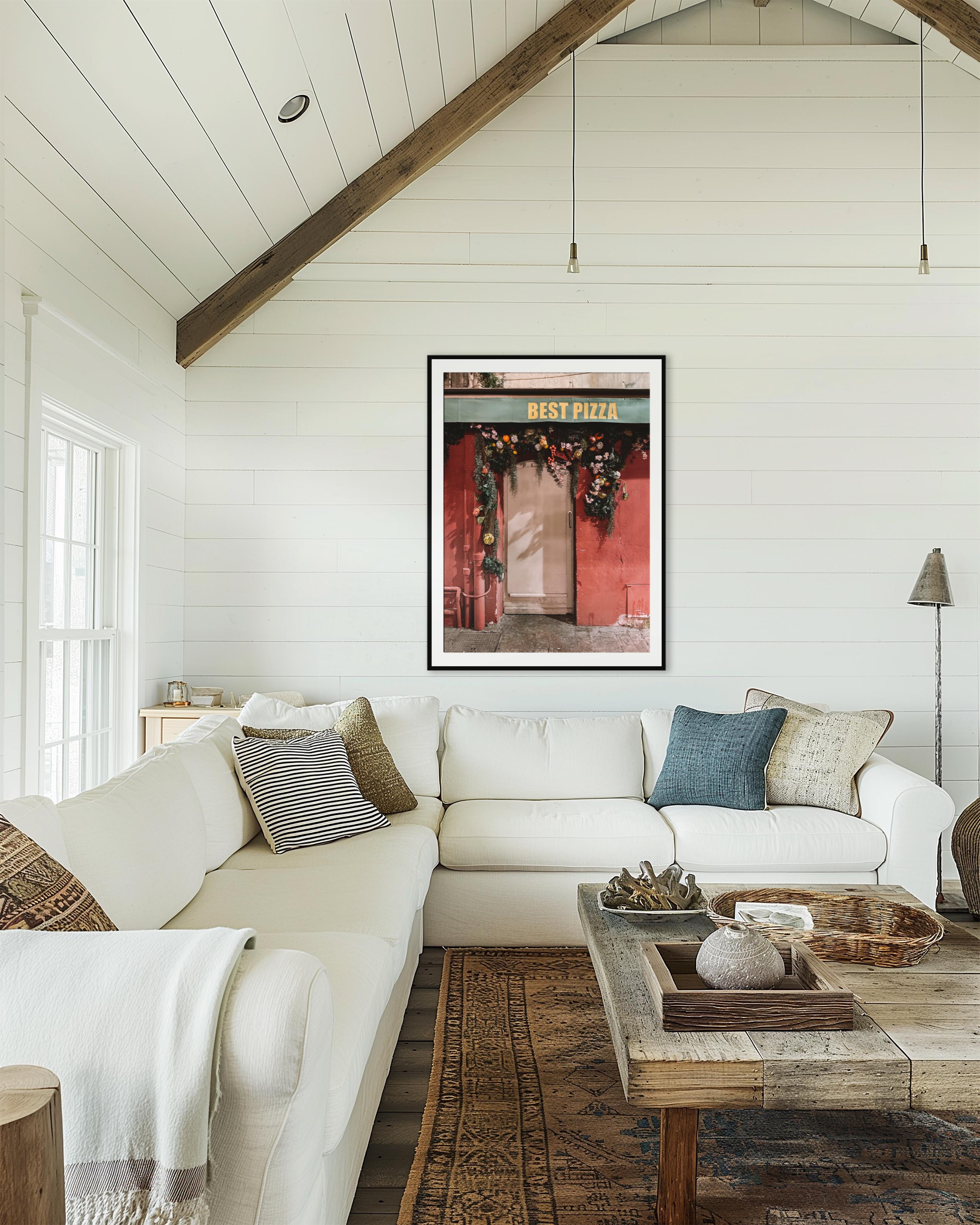 Living room with white sofa, wooden coffee table, and framed artwork on the wall.