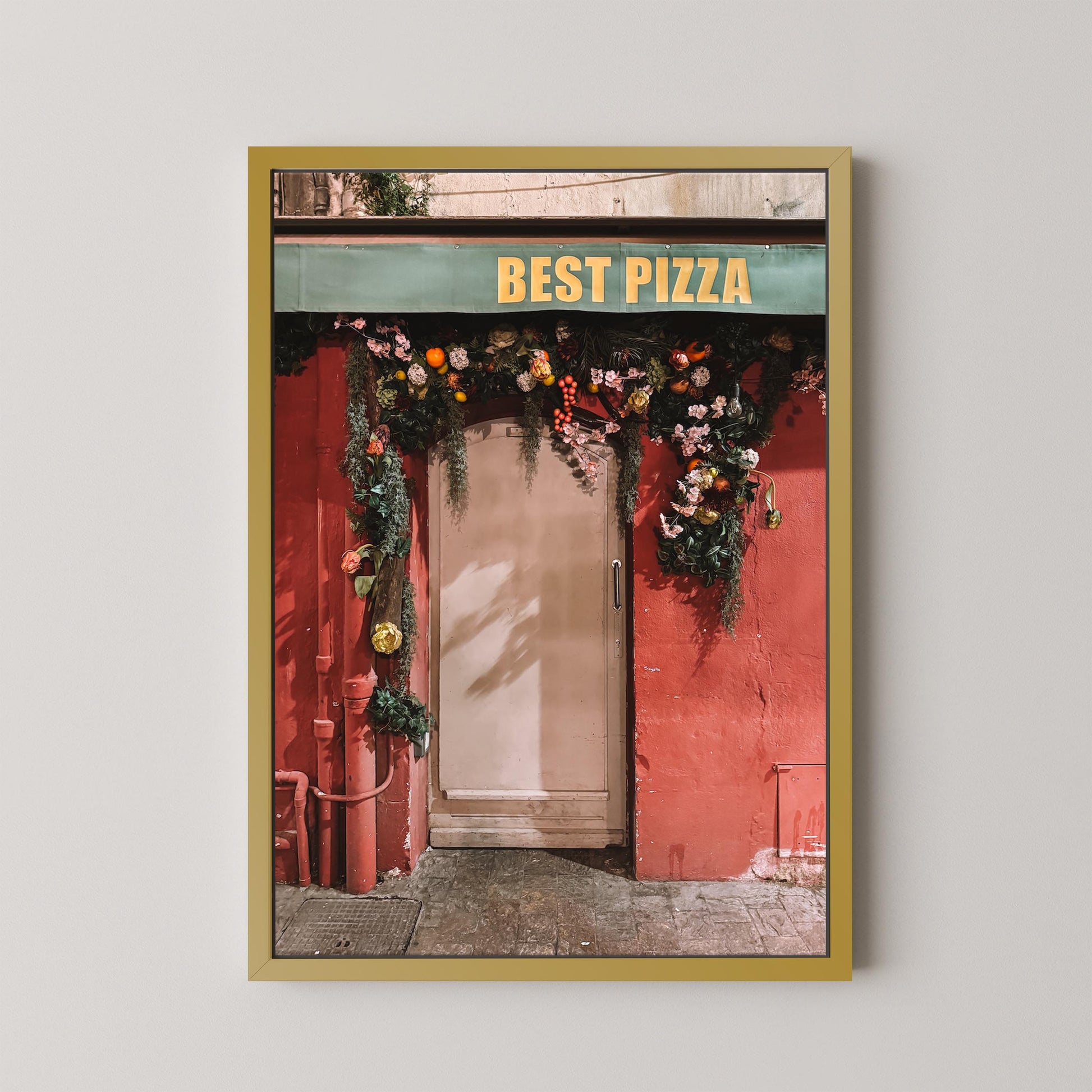 Framed photograph of a pizza shop entrance with 'Best Pizza' sign and floral decorations.