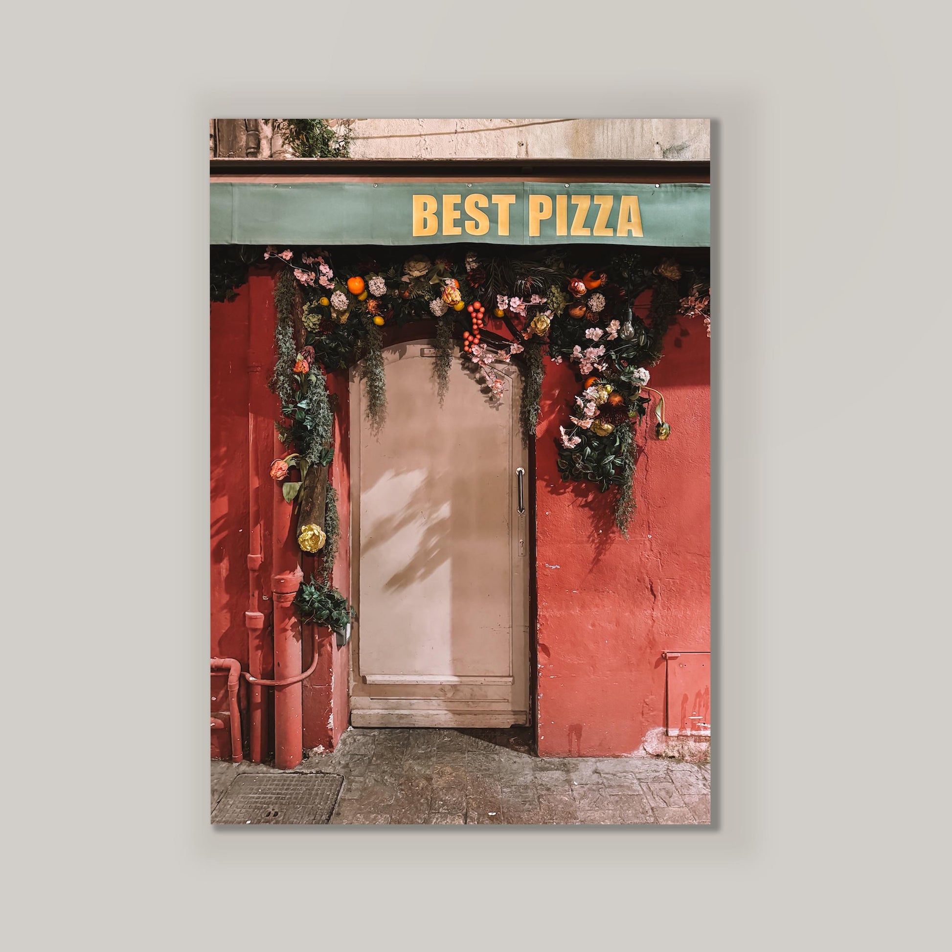 Decorative poster of a pizza shop entrance with flowers and 'Best Pizza' sign.