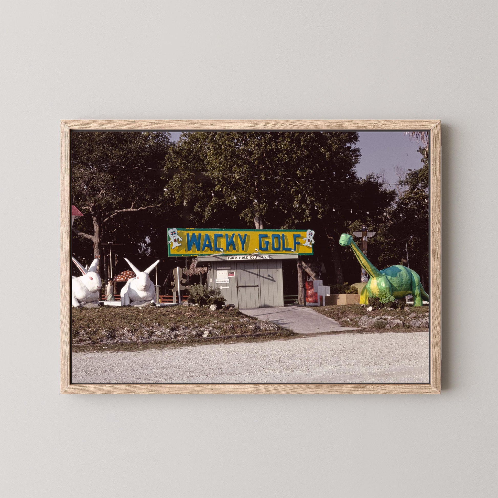 Framed photograph of a humorous roadside attraction with 'Wacky Golf' sign and cartoonish golf course.