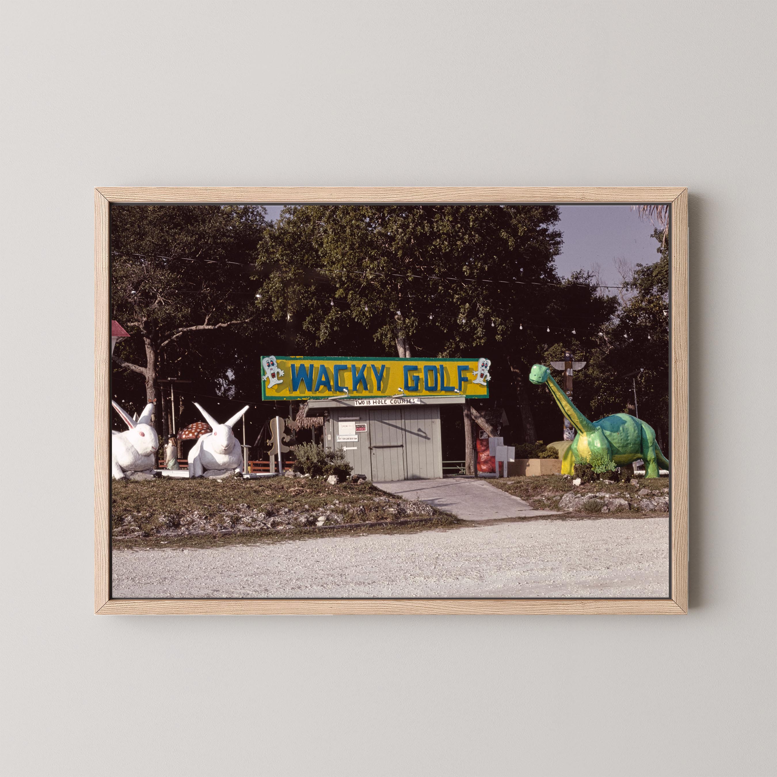 Framed photograph of a humorous roadside attraction with 'Wacky Golf' sign and cartoonish golf course.